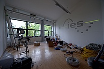 Room with tools and cables lying around and the IES logo on the wall.