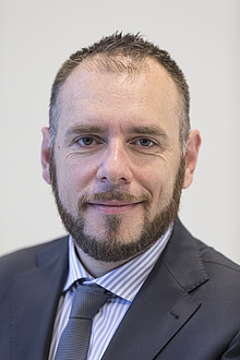 A man smiles into the camera