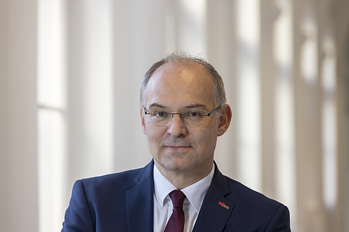 Smiling man with glasses.