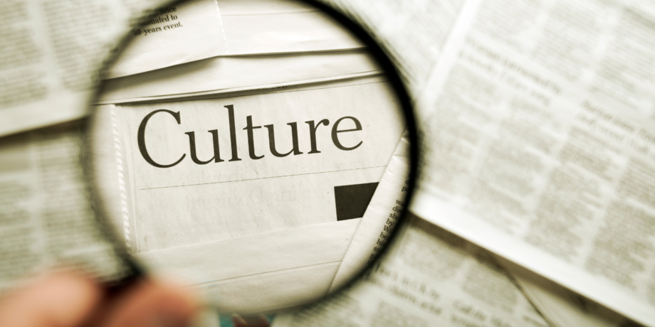 The word "culture" appears enlarged through a magnifying glass.