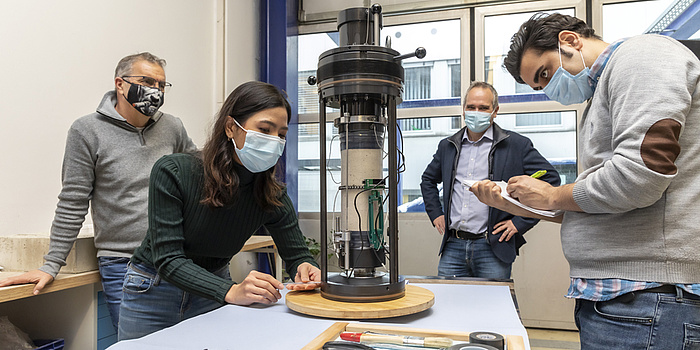 Anton Kaufmann, Kanthima Intachai, Thomas Marcher und Mehrdad Imani Tilenoei stehen in der Werkstatt 