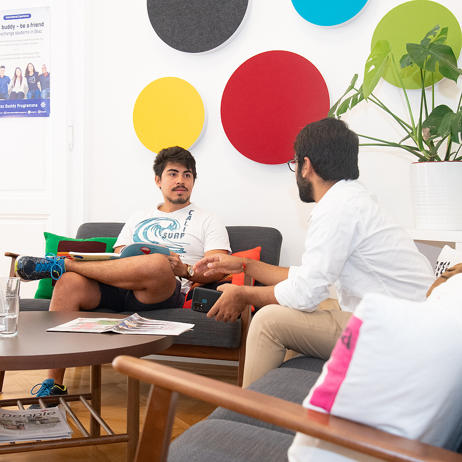 2 people sitting on couches and chatting