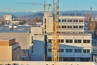 View from our new offices to our institute building which will be renovated within this year. In the back the snow-covered Koralpe can be seen.