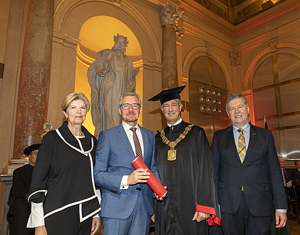 Group of people in festive attire and gown