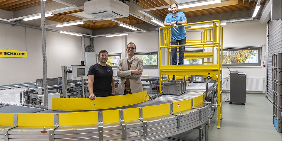 A picture of the round dance. Three men are standing behind it.