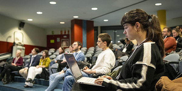 A group of students in a lecture hall.