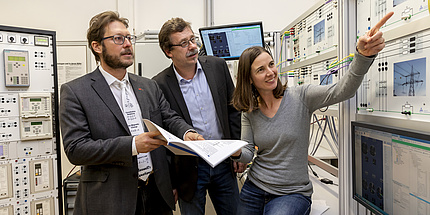Two men and one woman at a lab.
