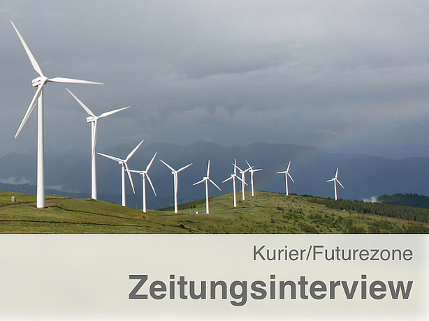 Wind power plants on a mountain with a rainbow.