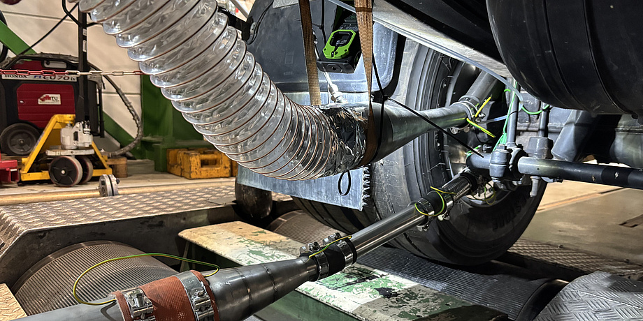 Photo of the underside of a car currently on a test bench. Hoses and pipes lead from the brake of a tyre to the side of the image.
