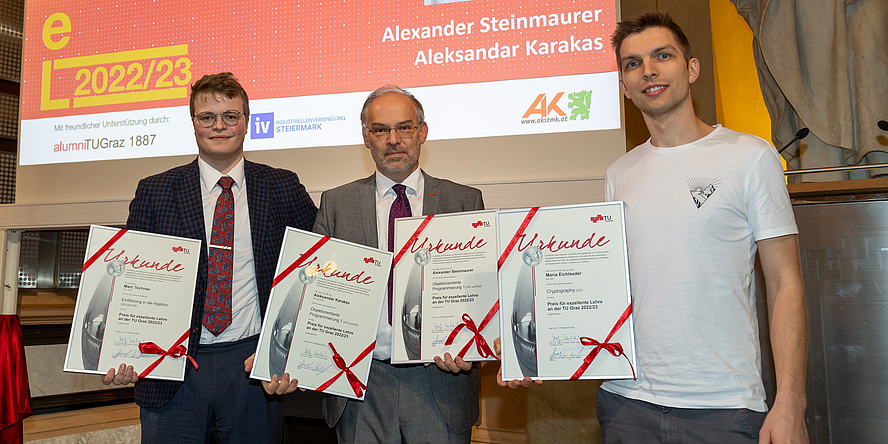 Three men with four certificates.