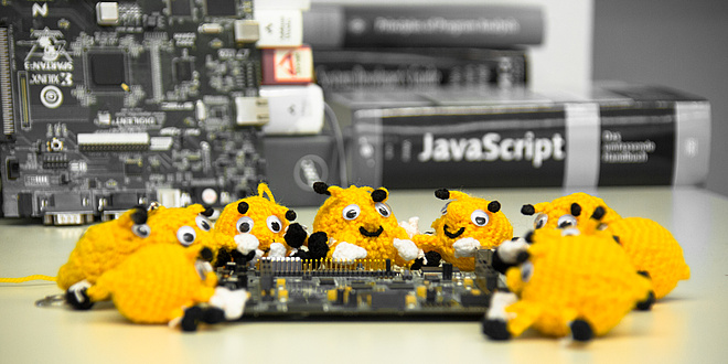 About ten hand-sized, crocheted beetle-like objects are draped around a circuit board.