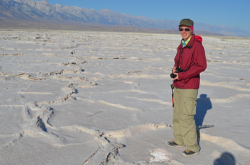 Warmly dressed person stands on floor surface with honeycomb-shaped elevations.