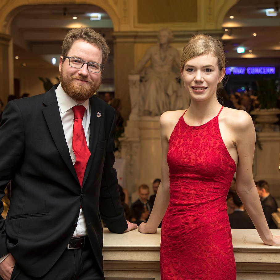 Young man and young woman wearing festive clothes.