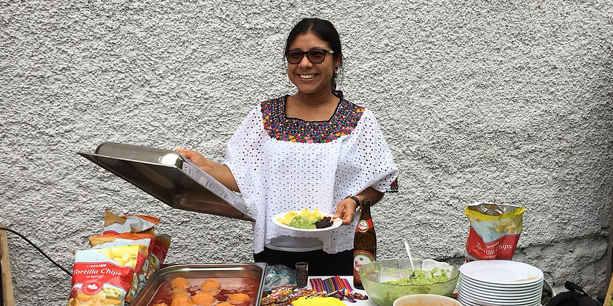 Young woman offers dishes from the buffet.