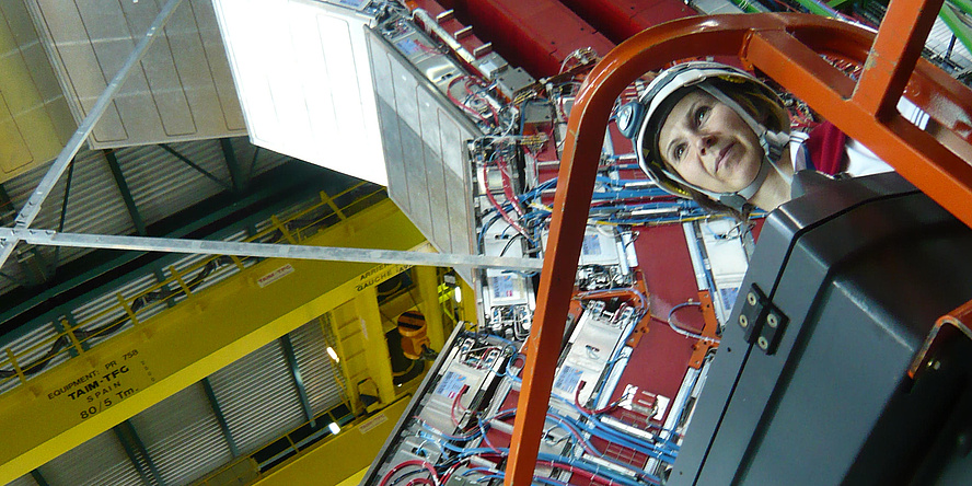 Woman with helmet on a crane platform