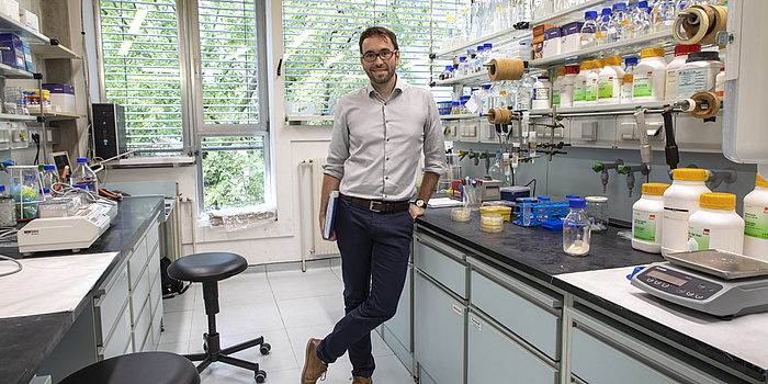 A man standing at a lab.