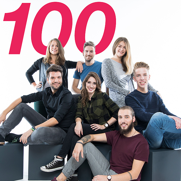 Young people of the study focus Information Security of TU Graz sit together, number 100 in the background