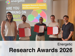 Five people stand smiling in a room, three holding red certificates in front of a projection screen showing the text “Energetic Research Awards: And the winners are…”, “ARE YOU WORKING ON ENERGY SUSTAINABILITY?” and the TU Graz logo.