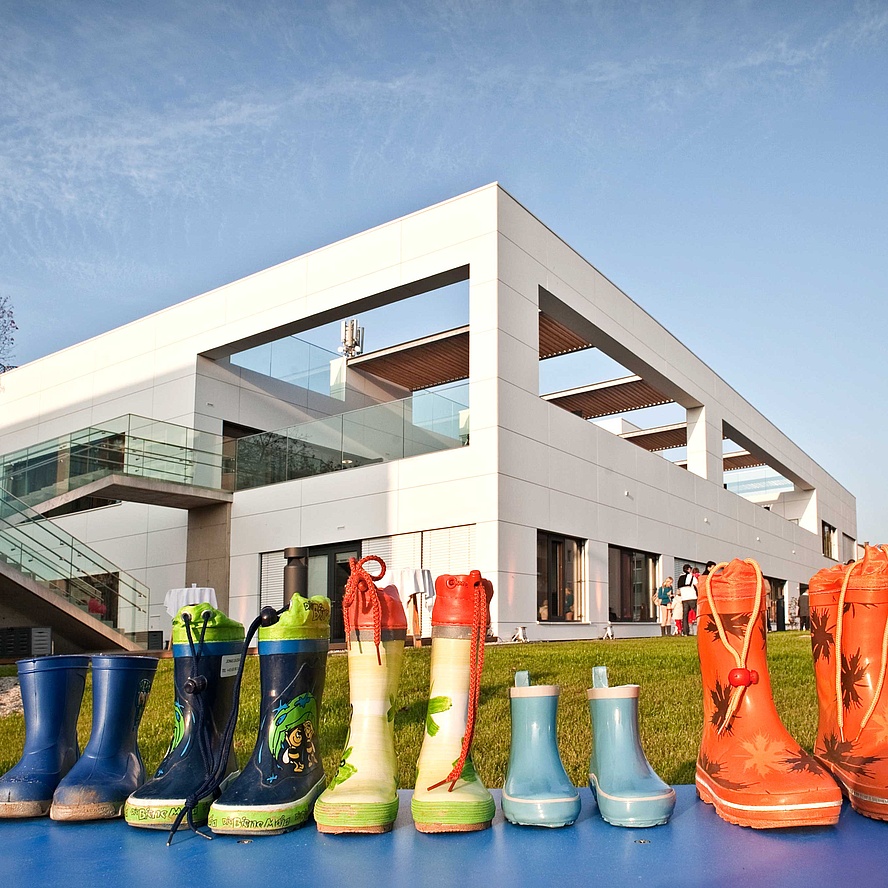 Children's rubber boots in front of a building