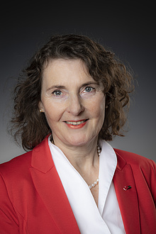 Portrait of Andrea Hoffmann in white blouse and red blazer