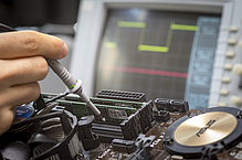 Close-up of the inner workings of a computer, followed by an electronic measuring device.