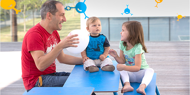 A man is sitting on the floor with children