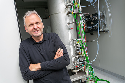 Smiling man with arms folded