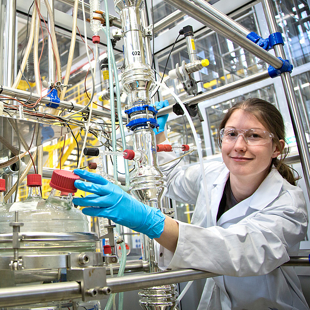 A young woman in a laboratory transforming substances.