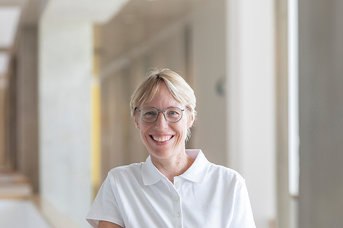 Woman in white polo shirt