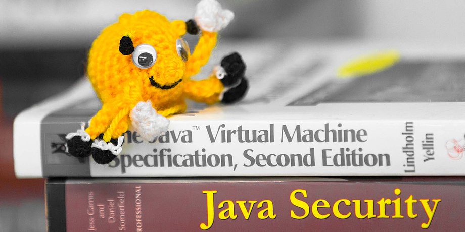 The bright yellow crocheted team mascot of LosFuzzys on a pile of books about IT security.