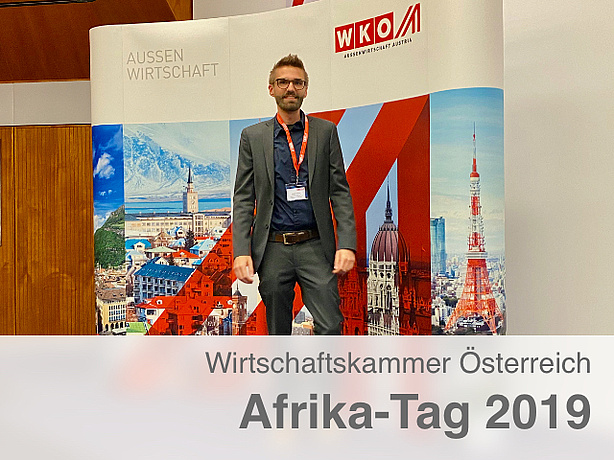 Robert Gaugl in front of a WKO banner at the Africa-Day 2019 conference.