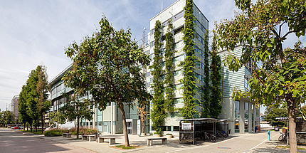Greened building complex at a road junction.