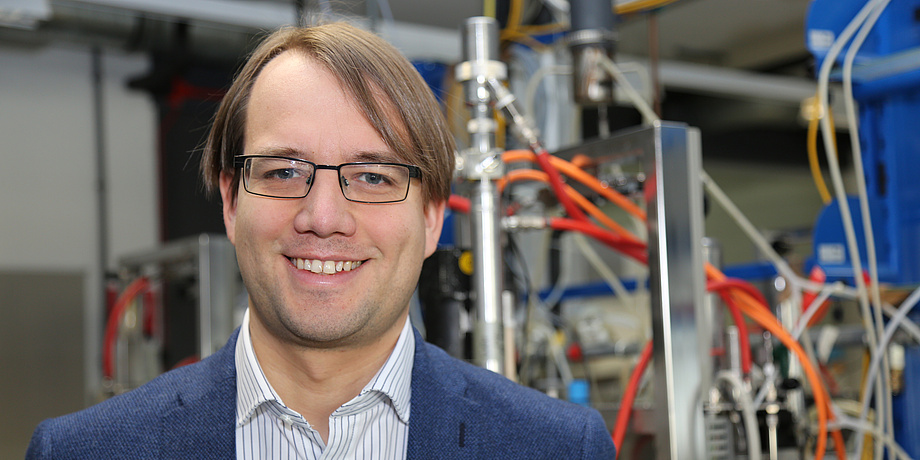 A man is standing inside a laboratory.