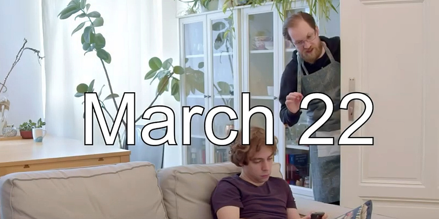 Two young men in a living room, above them the lettering "March 22".