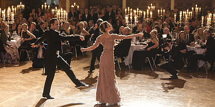 A dancing couple in festive attire