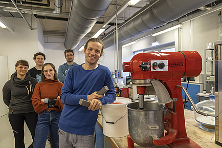 A group of people, including two women and three men.