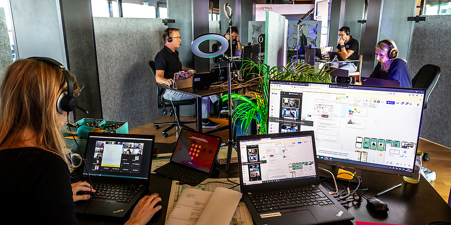 People work concentrated with a headset and in front of computers