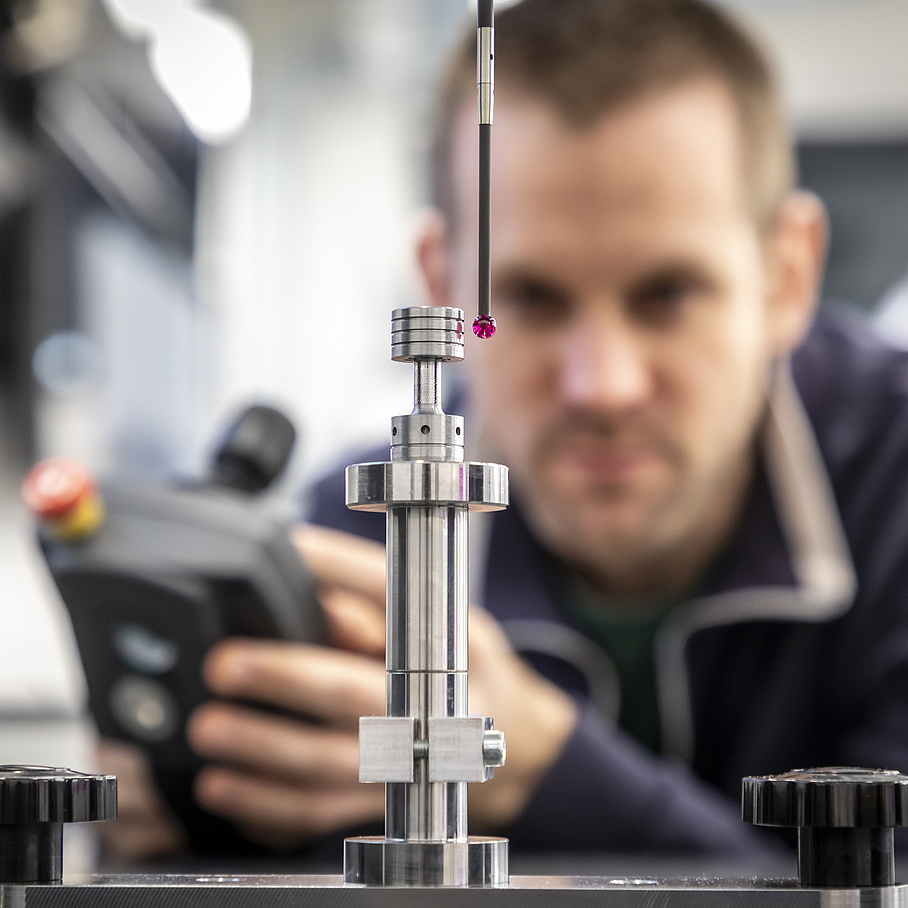 A person controls a milling machine