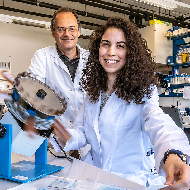 Two researchers in lab robes.