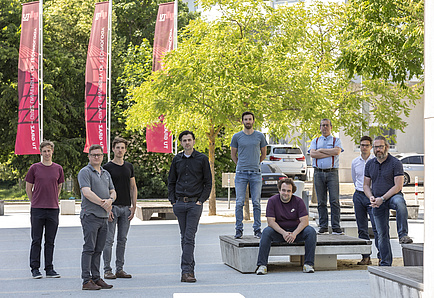 A group of nine men outdoors.