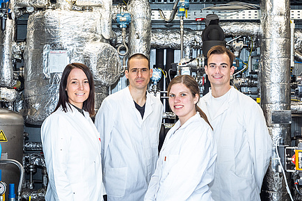 Four researchers in white coats