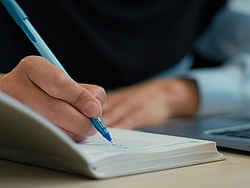 A person holding a pen.