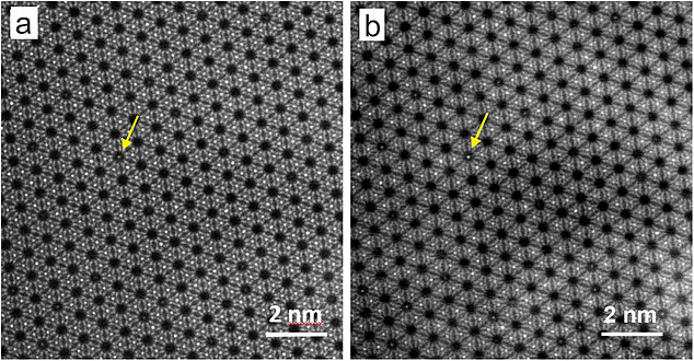 A yellow arrow points to a light-coloured dot in a dark gap of a regular crystal lattice.