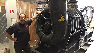 Emil Göttlich in front of the air supply compressor for our new wind tunnel provided by General Electric