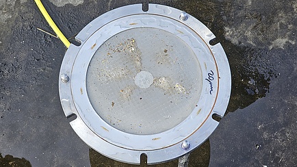 A metal ring with a very fine mesh filter net stretched across the centre.