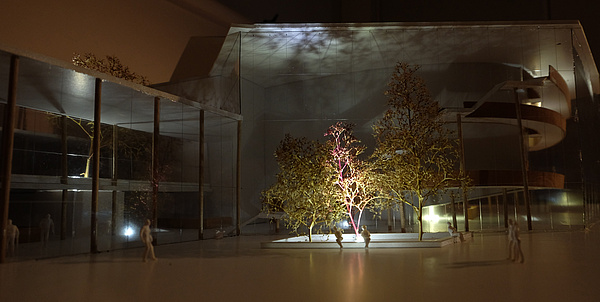 Architectural model of a house. In front of the model you can see a group of trees.