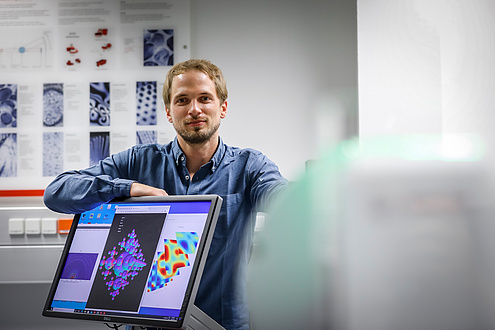 Researcher behind a computer screen