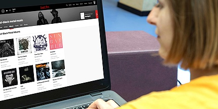 Woman uses music streaming service last.fm on desktop