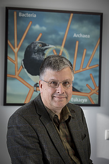 Man in front of poster with graphic representation