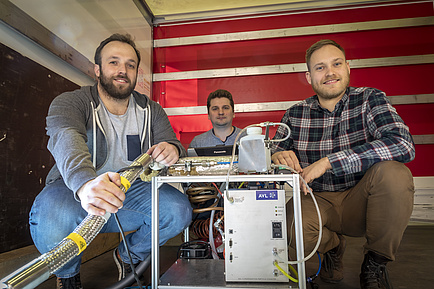 3 researchers with measuring device